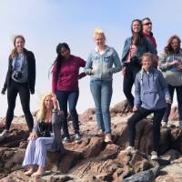 Students posed on a rocky cliff